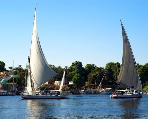 Two feluccas on the Nile River with Kitchener Island in the back, Aswan
