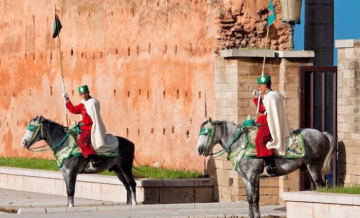 Places to visit in Rabat - Royal guard in front of Hassan Tower and Mausoleum of Mohammed V. Mausoleum contains tombs of late King Hassan II and Prince Abdallah. November 25, 2014 in Rabat, Morocco