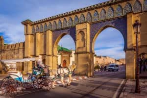 A tourist coach crosses Bab Moulay Ismail in front of the famous mausolem on December 23 2014 in Meknes, Morocco