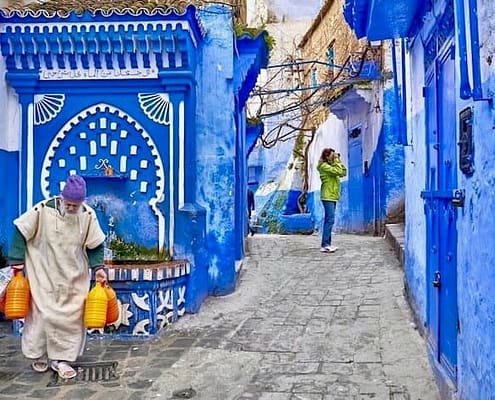 Group tours in Morocco. Local man carries water from the well. Chefchaouen, Morocco