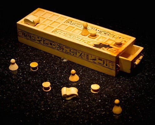 A game box and pieces for playing the game of Senet