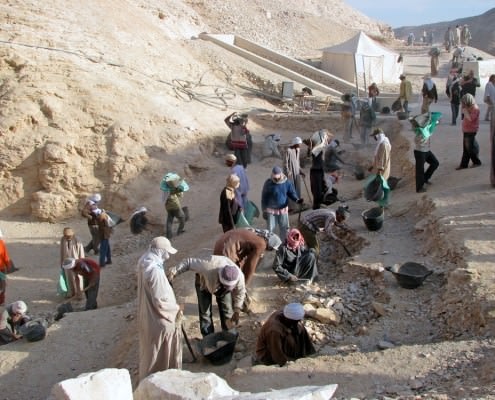 Workers sift through dirt and debris at an archaeological site at the Valley of the Kings