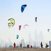 Kite beach in Jumeirah, Dubai, United Arab Emirates. A stretch of the beach designated for the kite surfers. The beach-goers are a colorful mix of different nationalities.