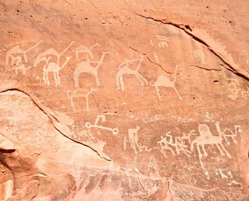 Images of camels carved into a rock wall at Wadi Rum, a UNESCO World Heritage site in Jordan