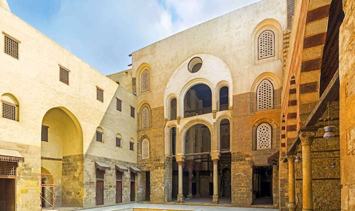 The courtyard Qalawun complex with the view on the arched rebuilt entrance to the medieval mosque