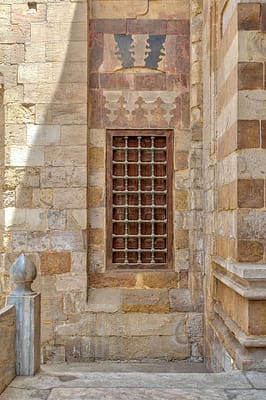 Window with iron bars on exterior stone bricks wall of Amir Aqsunqur Mosque (Blue Mosque)