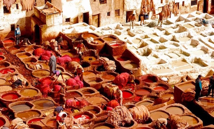 Local people painting leather at the tannery by the ancient way