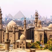Egypt Cultural Tours - The Mosque of Sultan Hassan and the Pyramids in the background, Cairo, Egypt