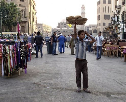 A boy selling bread in the square in front of the Mosque of Sayyidna al-Hussein
