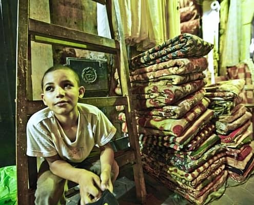 Boy in carpet store, Khan El Khalili Bazaar