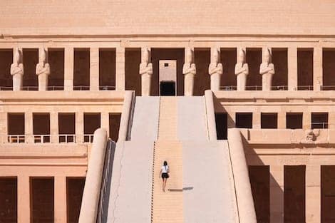 Hatshepsut Temple at sunrise in Valley of the Kings and red cliffs western bank of Nile river - Luxor- Egypt